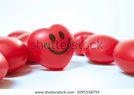 Red rubber heart smile on white background