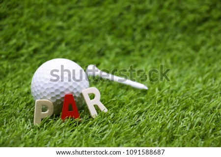 golf ball with wording PAR are on green grass