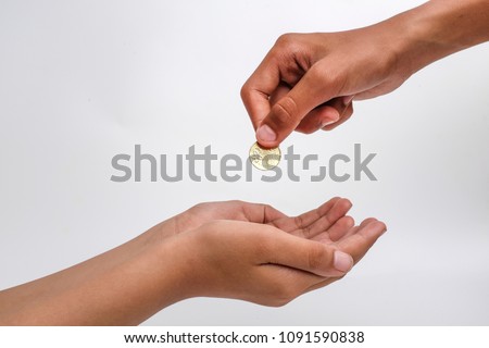 Close-up of a hand giving coin to another isolated on white background