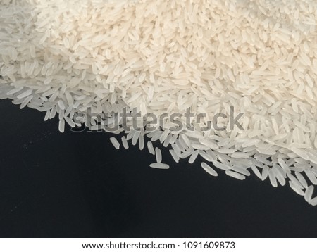 long grain rice jasmine on top black background