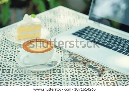 Coffee, cake and notebook on the table