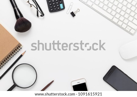 White office desk with smartphone, computer and office supplies top view