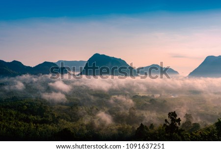 Landscape is fog and mountain.
