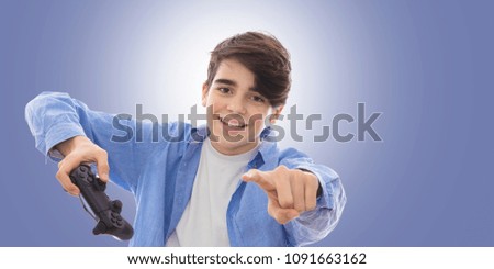 young man with console command playing video games