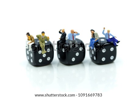 Miniature people : businessman sitting with dices,relax Business Concept.