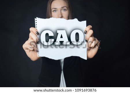 In the hands of a businessman a scrap of paper with the inscription:CAO