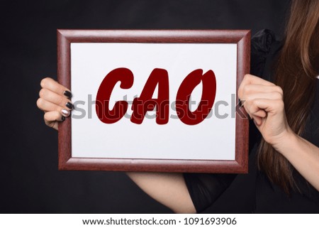 In the hands of a businessman a frame with the inscription:CAO