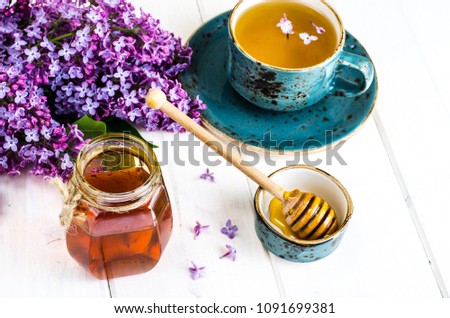 Organic honey in glass jar, purple lilac. Studio Photo