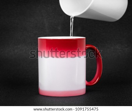Red coffee mug on dark background. Changing color when hot temperature.