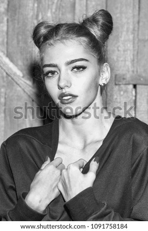 Full length view of one straight slender funny young smiling happy woman with cool hairstyle in black sweater with flexible body standing in studio on wooden backdrop, vertical picture