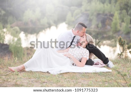 beautiful people love kissing, newlyweds, a young couple, outdoor session. The bride in a white dress. Love, wedding and passion