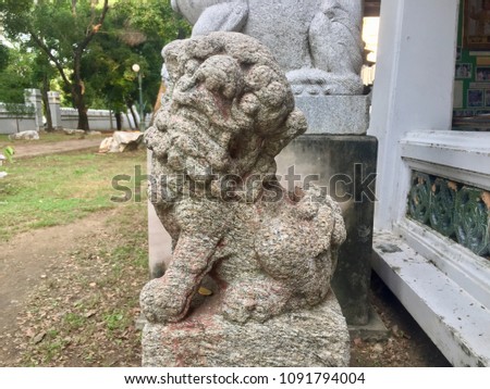 The old statue in Thai temple. Animal carvings are called Singha in the temple to protect  the evils and the bad things not be allowed in the temple. This type of art is believed to come from China.