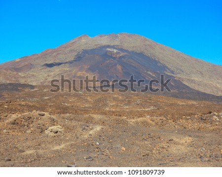 Mount Teide , active Volcano in the centre of Tenerife . Shows the rugged terrain around this volcano. It's beauty disguises the danger - this volcano was threatening to erupt just before the picture 