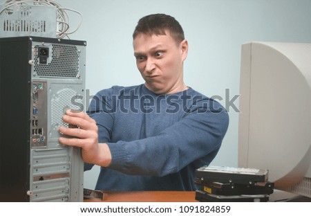 Overloaded computer repairman tired from his work and goes crazy. Computer technician. PC repair service center.