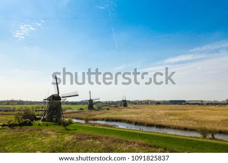 Aerial view of Netherlands rural landscape with windmills at famous tourist site Kinderdijk in Holland. Sunny spring day in countryside