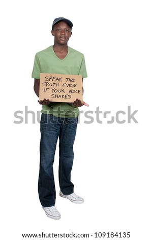 Young teenage black African American man holding up a sign that says Speak The Truth Even If Your Voice Shakes