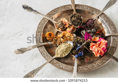 Various flavors of tea. Green tea flower tea matcha karkade in spoons in a vintage plate