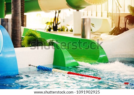 Water slides in a water park of different colors blue, red, yellow