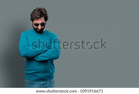 young crazy man with beard and blue sweater. angry expression