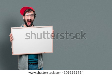 young crazy man with beard and red cap with an empty placard to place your concept