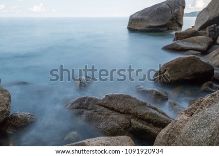 Long exposure shot.Beautiful sea scape with stone beach on a summer vacation,Motion blur,slow shutter speed.
