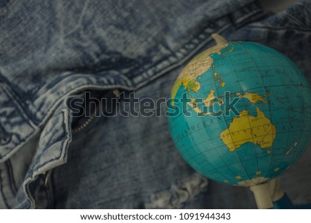 soft focus globe on jeans background texture with empty space for copy or text