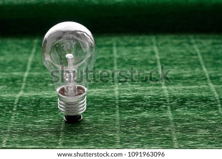 Light bulb on green background. Minimal concept. Copy space