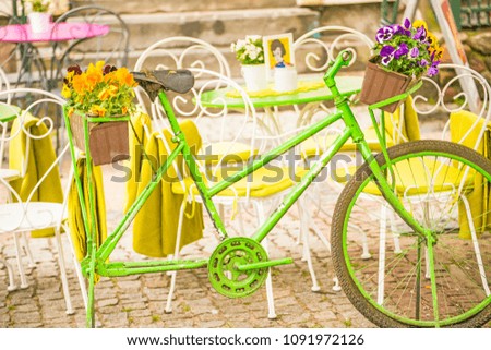 bicycle with flowers at a street cafe