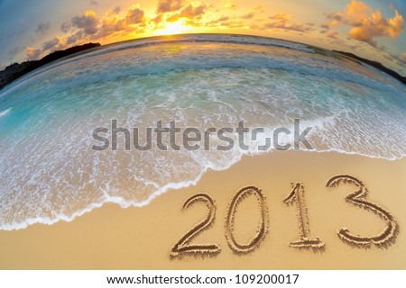new year 2013 digits on ocean beach sand Royalty-Free Stock Photo #109200017