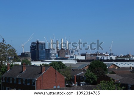 Rooftop skyline view of Battersea Power Station under construction in May, 2018, against a blue sky on a sunny day.