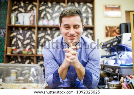 Image of barista man in cafe on background of coffee machine