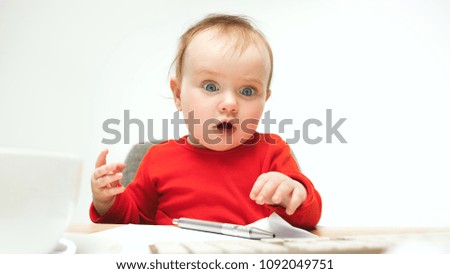 How many documents can I sign? child baby girl sitting with keyboard of modern computer or laptop in white studio background. Businesswoman, lady boss and girl-boss concepts