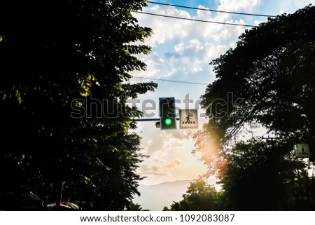 Green traffic light in the city street.