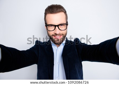 Self portrait of positive cheerful teacher shooting selfie on front camera with two arms during timeout break pause isolated on grey background