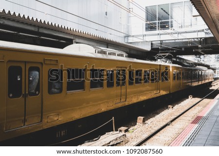 Japanese local train, which full of passenger parked at station platform. Vintage picture tone edition