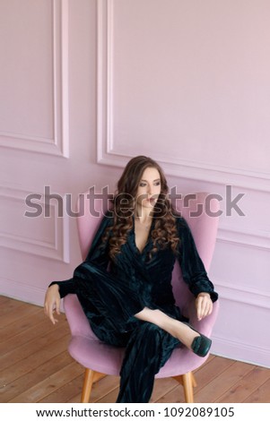 fashionable girl in trouser suit in photo studio