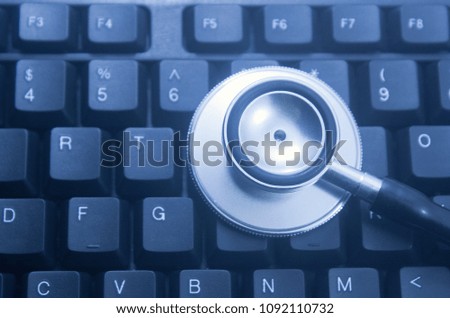 Computer or data analysis - Stethoscope over a computer keyboard toned in blue