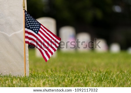 Small American flags and headstones at National cemetary- Memorial Day display Royalty-Free Stock Photo #1092117032