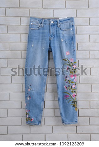 Embroidered flowers blue jeans isolated-front view
