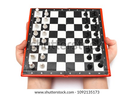 Mini compact portable chess with small figures in hands isolated on a white background