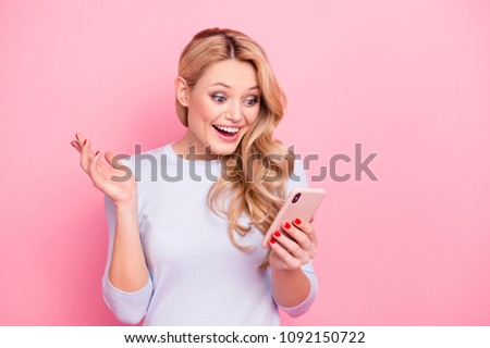 Portrait of wondered woman, excited student, shocked girlfriend having smart phone cellphone in hands watching picture video reading news isolated on pink background Royalty-Free Stock Photo #1092150722