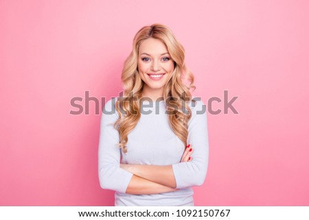 Portrait of lovely charming attractive girl with modern hairstyle looking at camera holding arms crossed isolated on pink background