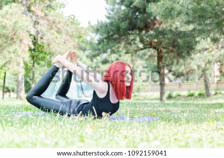 Woman doing morning yoga exercises in mountain woods near yellow tourist tents, Active Lifestyle, Travel, vacation, holidays and adventure concept.