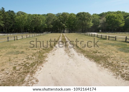grass parking lot with dirt road