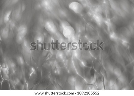 Abstract blurred background. Beautiful lines and light spots of blurred metal net with defocused bokeh