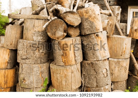 Stack of firewood in the village. Preparation of firewood for the winter 