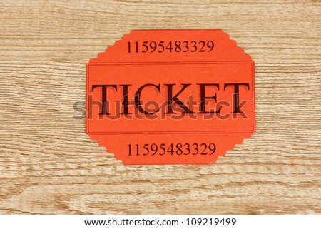 Colorful ticket on wooden background close-up