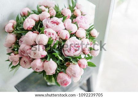 Lovely flowers in glass vase. Beautiful bouquet of pink peonies . Floral composition, scene, daylight. Wallpaper