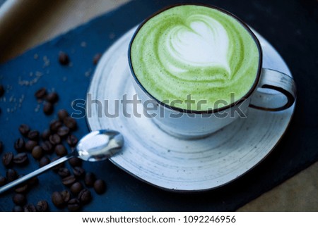 A cup with a beautiful green coffee closeup