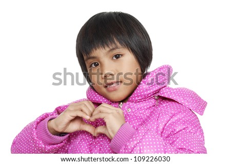 little girl makes a gesture in the form of the heart